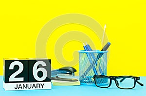 January 26th. Day 26 of january month, calendar on yellow background with office supplies. Winter time