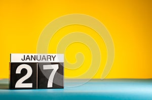 January 27th. Day 27 of january month, calendar on yellow background. Winter time. Empty space for text