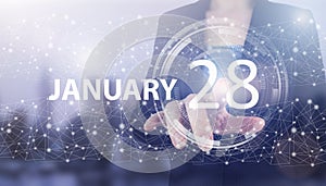 January 28th. Day 28 of month, Calendar date. Hand click luminous hologram calendar date on light blue town background. Winter