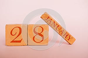 january 28th. Day 28 of month, handmade wood calendar  on modern color background. winter month, day of the year concept