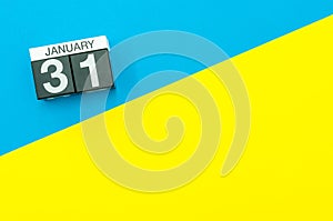 January 31st. Day 31 of january month, calendar on blue and yellow background flat lay, top view. Winter time. Empty