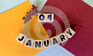 January 4 on a multi-colored background on wooden cubes. Calendar for January.