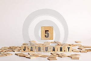 January 5 displayed on wooden letter blocks on white background