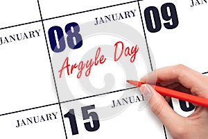 January 8. Hand writing text Argyle Day on calendar date. Save the date.
