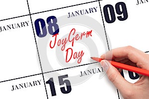 January 8. Hand writing text JoyGerm Day on calendar date. Save the date.