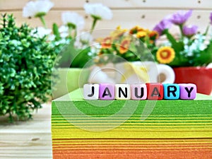 January. Colorful cube letters on sticky note block.