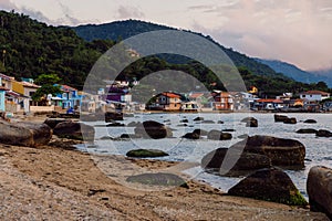 January 19, 2022. Florianopolis, Brazil. Colorful houses in Ribeirao da Ilha village and sea coastline at sunset