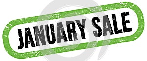 JANUARY SALE, text written on green-black stamp sign