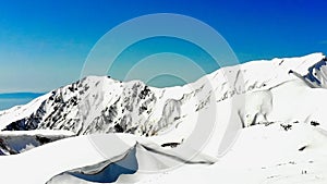 The japan alps or the snow mountains of Tateyama Kurobe alpine in sunshine day with blue sky