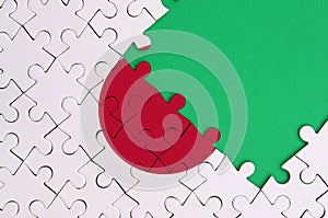 Japan flag is depicted on a completed jigsaw puzzle with free green copy space on the right side