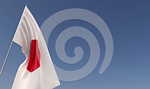 Japan flag on flagpole on blue background. Place for text. The flag is unfurling in wind. Japanese. Asia, Tokyo. 3D illustration