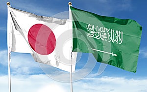 Japan flag and Saudi Arabia flag on cloudy sky photo