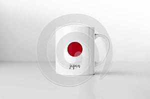 Japan flag on white coffee mug.