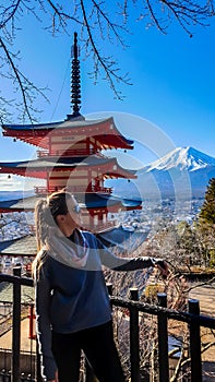 Japan - A girl posing with Chuerito Pagoda and Mt Fuji in the back