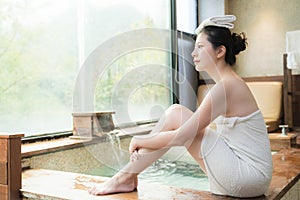 Japan girl sitting on poolside of hot springs