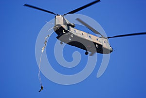 Japan Ground Self-Defense Force paratroopers jump out the back of a CH-47J Chinook heavy-lift helicopter.