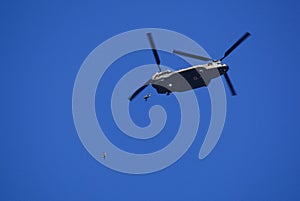 Japan Ground Self-Defense Force paratroopers jump out the back of a CH-47J Chinook heavy-lift helicopter.