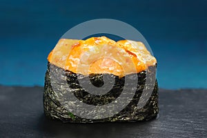 Japan gunkanmaki sushi baked with cheese on blue background