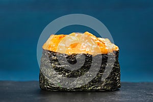 Japan gunkanmaki sushi baked with cheese on blue background
