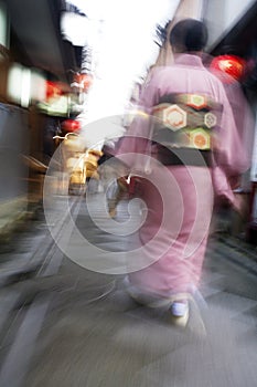 Japan Kyoto Pontocho-dori Woman wearing kimono walking on narrow street motion blur