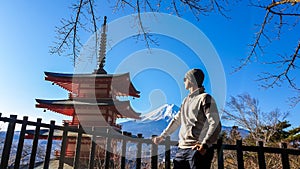 Japan - A man posing with Chuerito Pagoda and Mt Fuji in the back