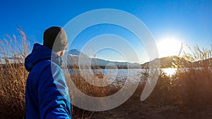 Japan - A man standing at the side of Kawaguchiko Lake with the view on Mt Fuji