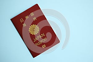 Japan passport on blue background close up