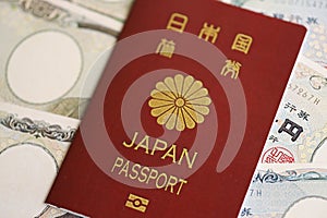 Japan passport with japanese yen money bills on table close up. Tourism and travel