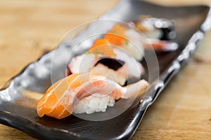 Japan raw salmon sushi and fresh mix sushi set in black plate - Japanese food set style at Japanese restaurant