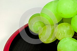 Japan`s green Muscat placed on a red lacquer ware