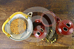 Japan's teapot and cups with green tea on wooden plank