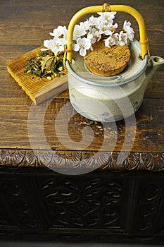 Japan's teapot with green tea and sakura flowers