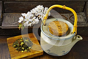 Japan's teapot with green tea and sakura flowers