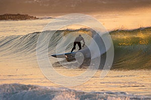 Japan Surf, a man surf many waves on many Surf boards during sunrise and sunset in a blue ocean. Surfing In Japan