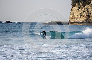 Japan Surf, a man surf many waves on many Surf boards during sunrise and sunset in a blue ocean. Surfing In Japan