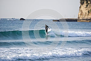 Japan Surf, a man surf many waves on many Surf boards during sunrise and sunset in a blue ocean. Surfing In Japan