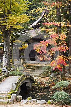 Japan Takayama Hokke-ji Temple garden with stone bridge Autumn