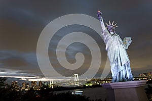 Japan, Tokyo, night view of the bay with its bridge and Statue of Liberty