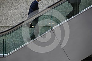 Japan Tokyo Tokyo International Forum two men ascending escalator mid section