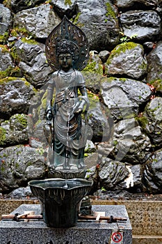 Japan water spring from steel statue of god woman