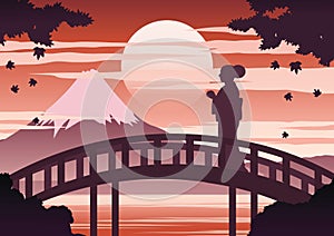 Japan woman in kimono dress stand on bridge near Fuji mount on sunset time while maple fall,silhouette light and shadow design,