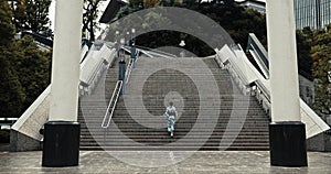 Japan, woman and kimono outdoor on stairs for wellness, heritage celebration and culture in Tokyo city. Sanno Torii