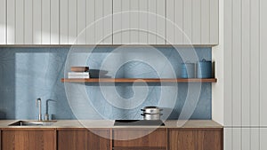 Japandi wooden kitchen close up in white and blue tones. Modern cabinets, wallpaper, shelf with decors and induction hob.