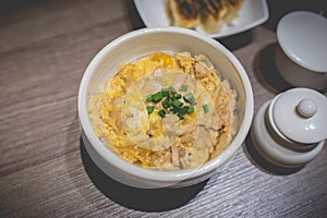 Japanes food gyudon or butadon with egg lunch meal on wood table