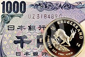 Japanese 1000 yen bank note with a gold Krugerrand coin