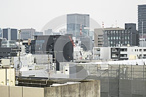 Japanese abstract urban background featuring details of chaotic city buildings and skyline in Tokyo