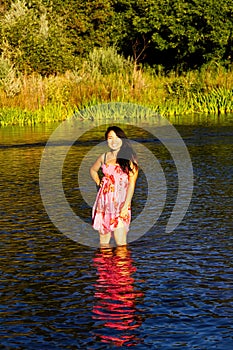 Japanese American Woman Standing In River Pink Dress