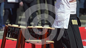 Japanese artist playing on traditional taiko drums