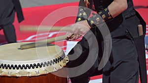 Japanese artist playing on traditional taiko drums