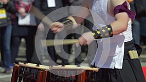 Japanese artist playing on traditional taiko drums